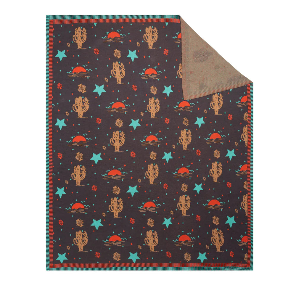 Starry Night Throw. A vibrant throw with a starry desert night pattern featuring turquoise stars and russet cacti on a deep brown sky background, flipped to show a soothing earth-toned pattern.