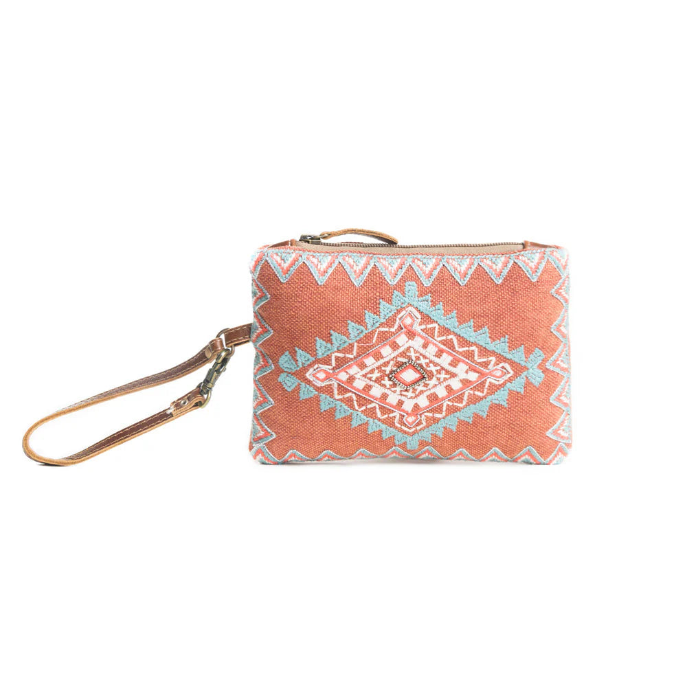 Women's Desert Sunrise Clutch Pouch. A clutch pouch with geometric patterns in terracotta and turquoise colors, featuring a zipper top and a wristlet strap.