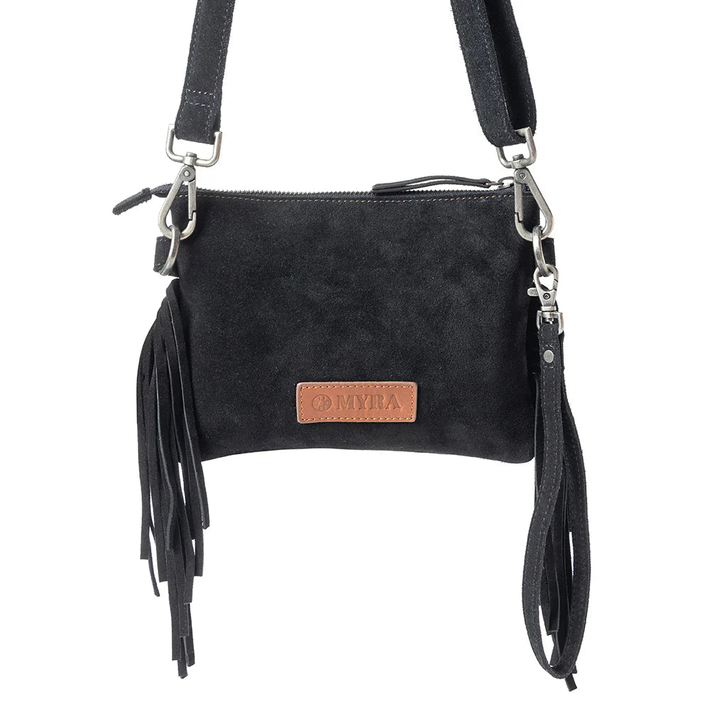 Desert Wing Crossbody Bag In Black. Black suede handbag with fringes and a visible brand logo on a white background