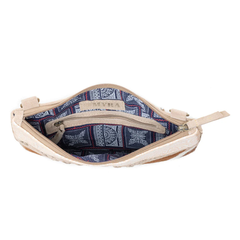Mesa Rebel Hairon Western Handbag in Spotted Tan. Open beige pouch with blue and white patterned interior on a white background