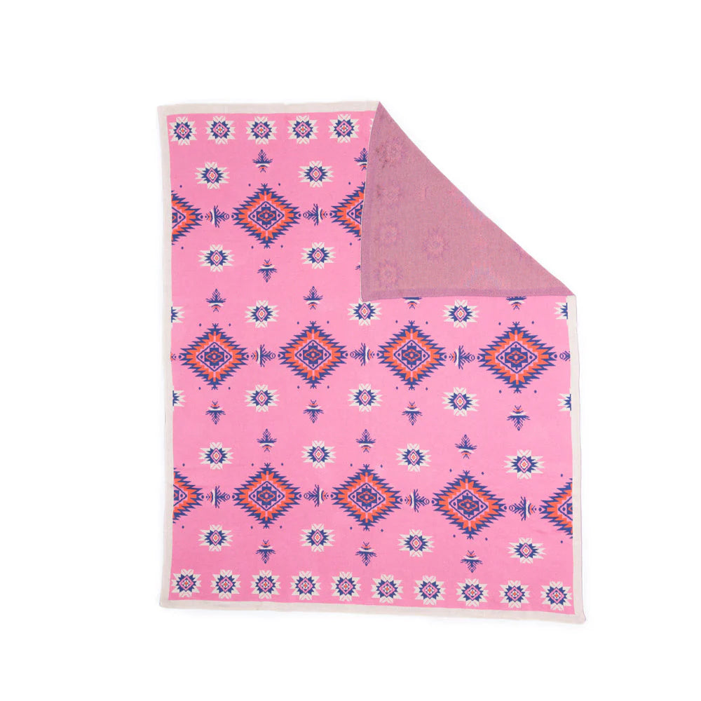 Pink blanket with geometric pattern on a white background