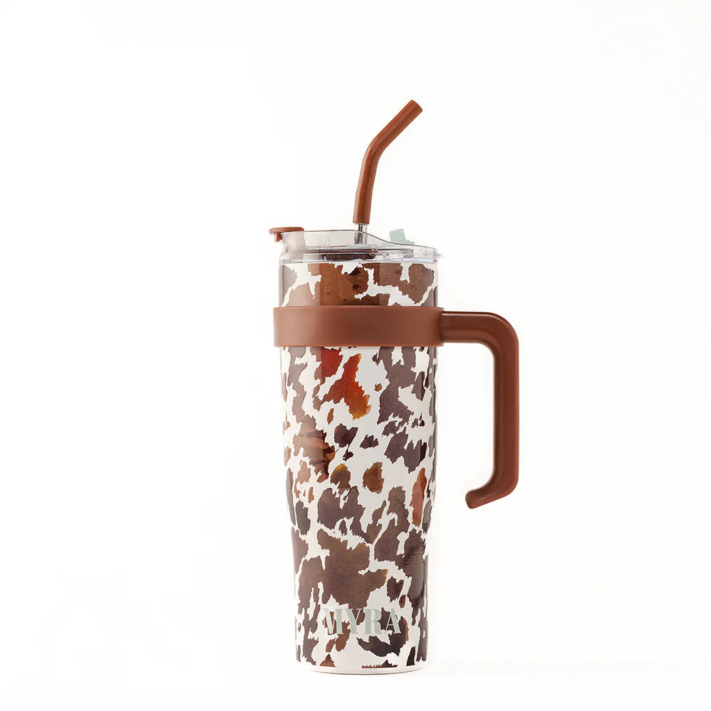 Wide Wyoming Tumbler In Brown and White. Tumbler with cow print design and brown handle on a white background