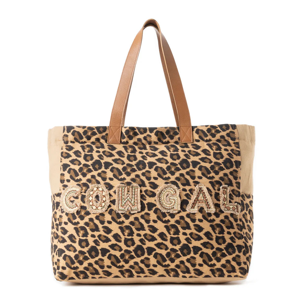 Panthera Cowgirl Weekender Bag in Jaguar Print. Leopard print tote bag with 'COOGI' branding on a white background