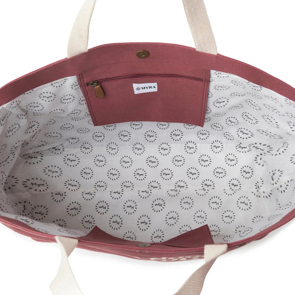 Open tote bag with floral patterned interior and visible brand logo.