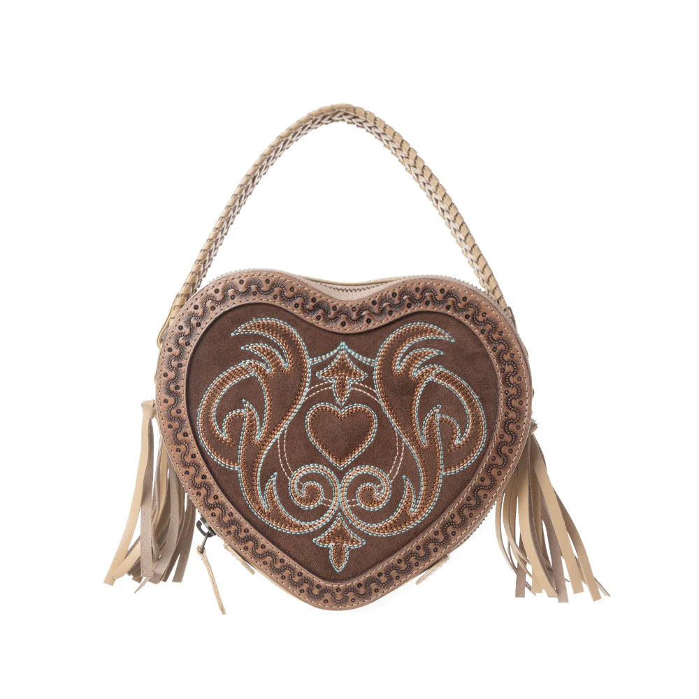 Heart-shaped handbag with intricate designs and tassels on a white background