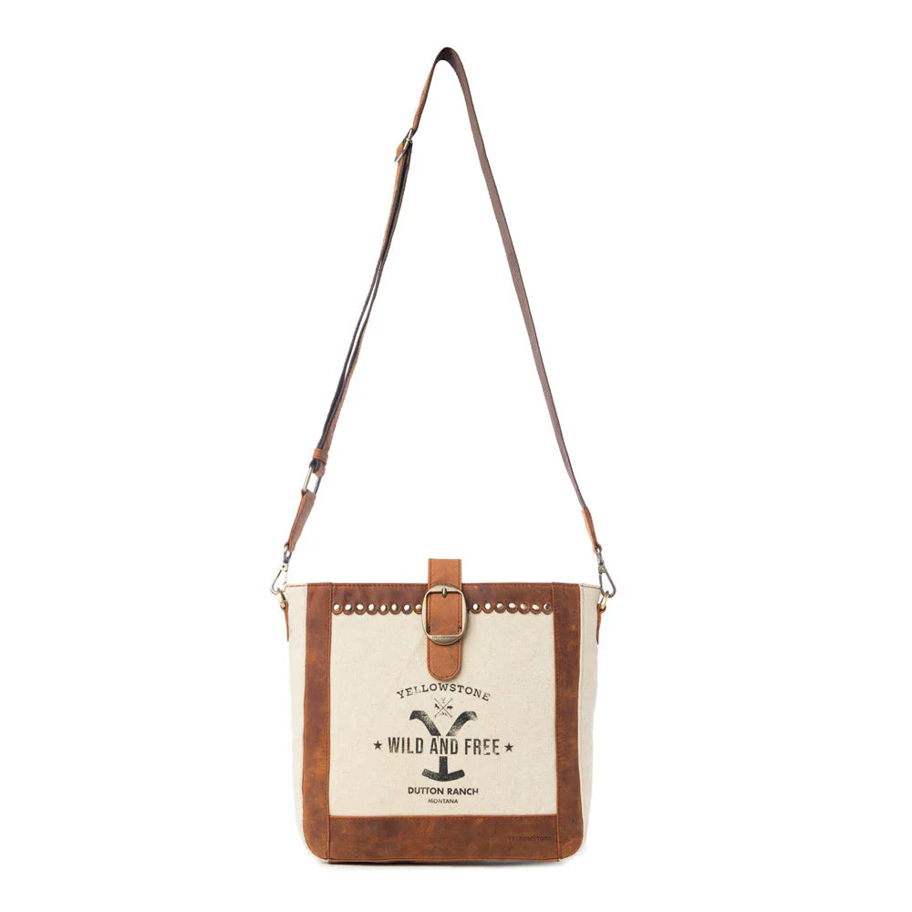 Yellowstone Lone Star Ivory Satchel Bag. Canvas and leather crossbody bag with 'Yellowstone' branding on a white background