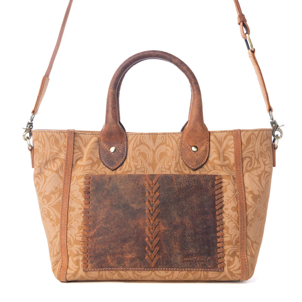 Yellowstone Wrangler’s Trail Crossbody with Pockets in Amber. Brown leather handbag with embossed design on a white background