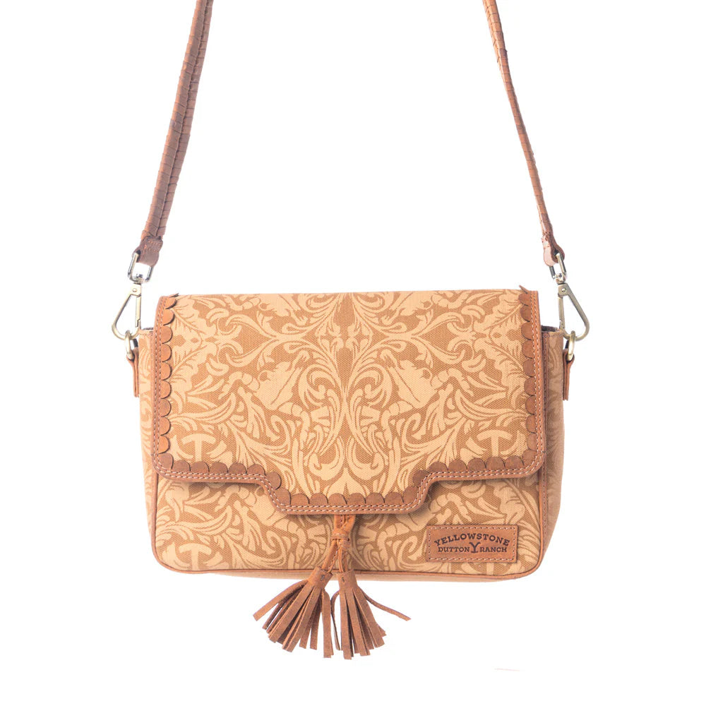 Yellowstone Sierra Amber Tassle Crossbody Bag. Brown leather handbag with intricate patterns and a tassel on a white background