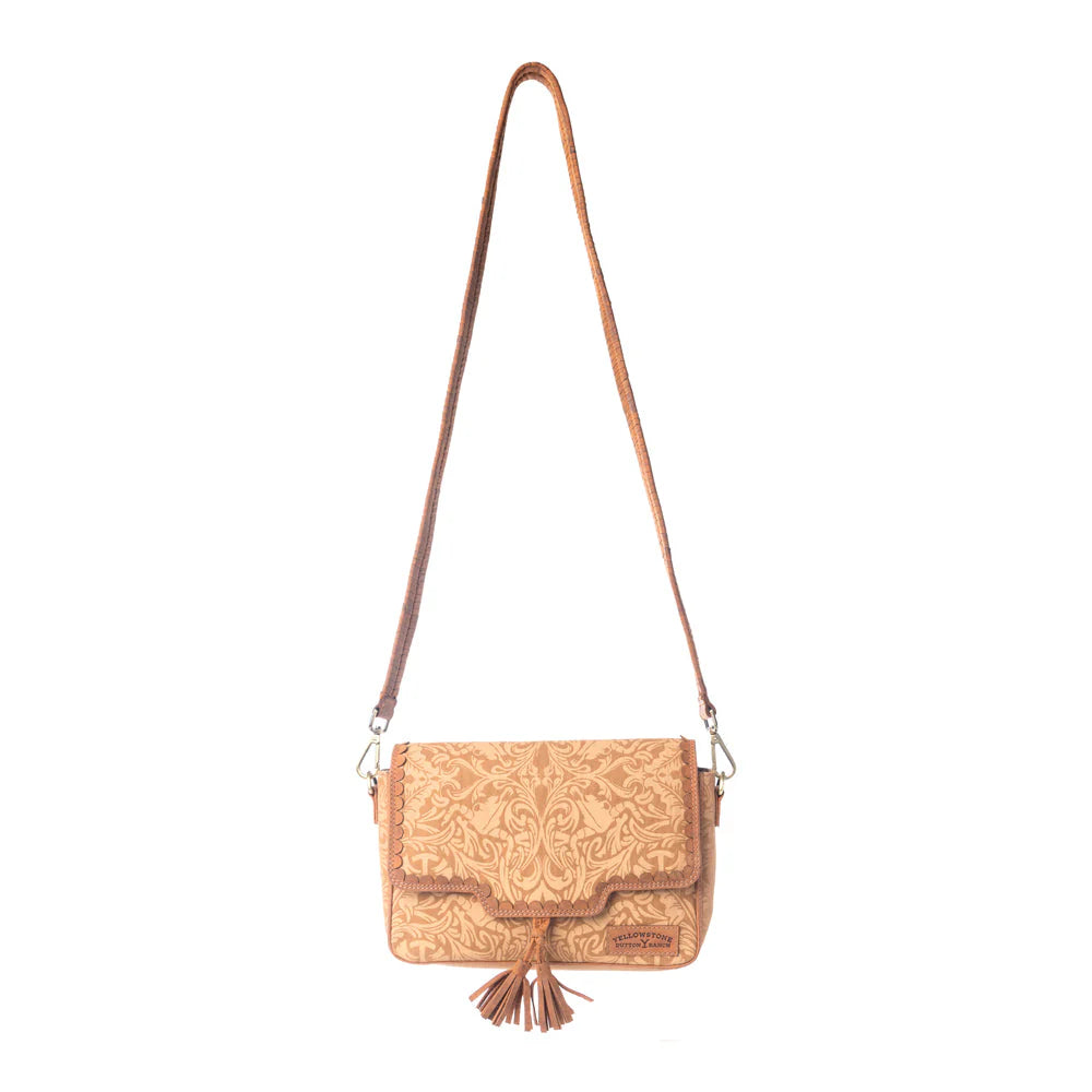 Yellowstone Sierra Amber Tassle Crossbody Bag. Brown leather handbag with intricate patterns on a white background