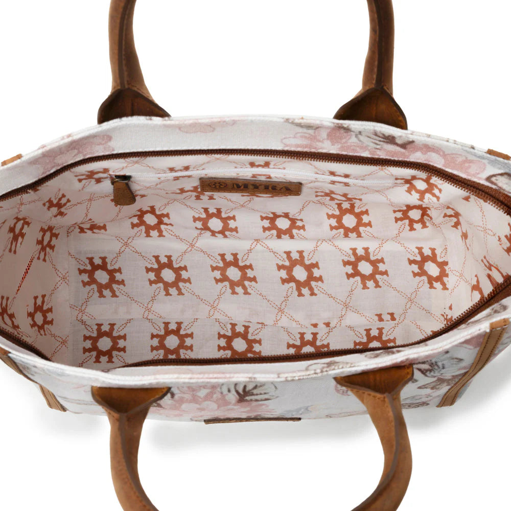 Patterned handbag with wooden handles on a white background