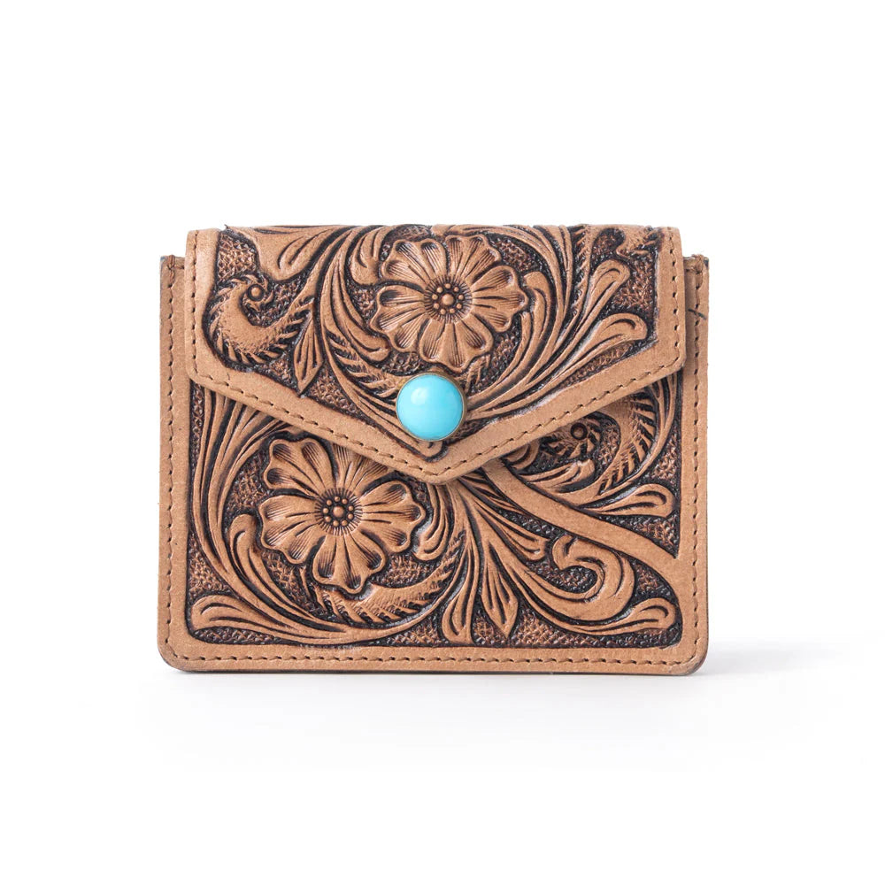 Tooled leather wallet with floral patterns and a turquoise stone on a white background