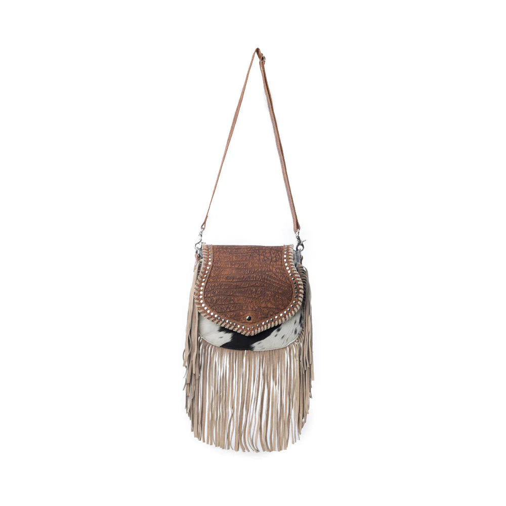 Brown handbag with fringe details on a white background