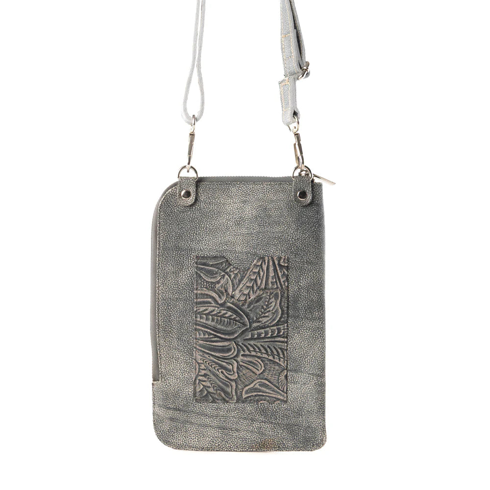 Silver leather crossbody bag with embossed design on a white background