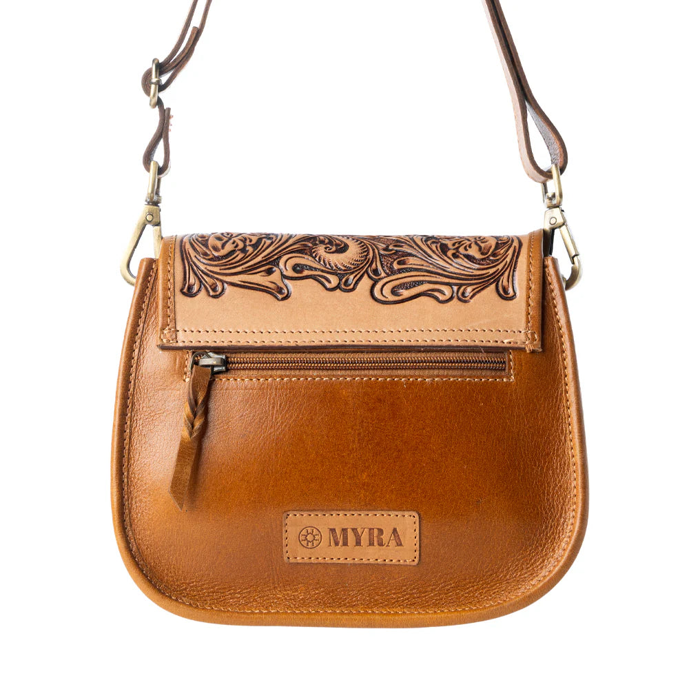Brown leather handbag with intricate designs and 'MYRA' branding on a white background
