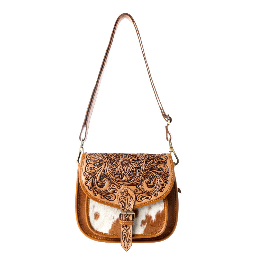 Brown leather handbag with intricate patterns on a white background