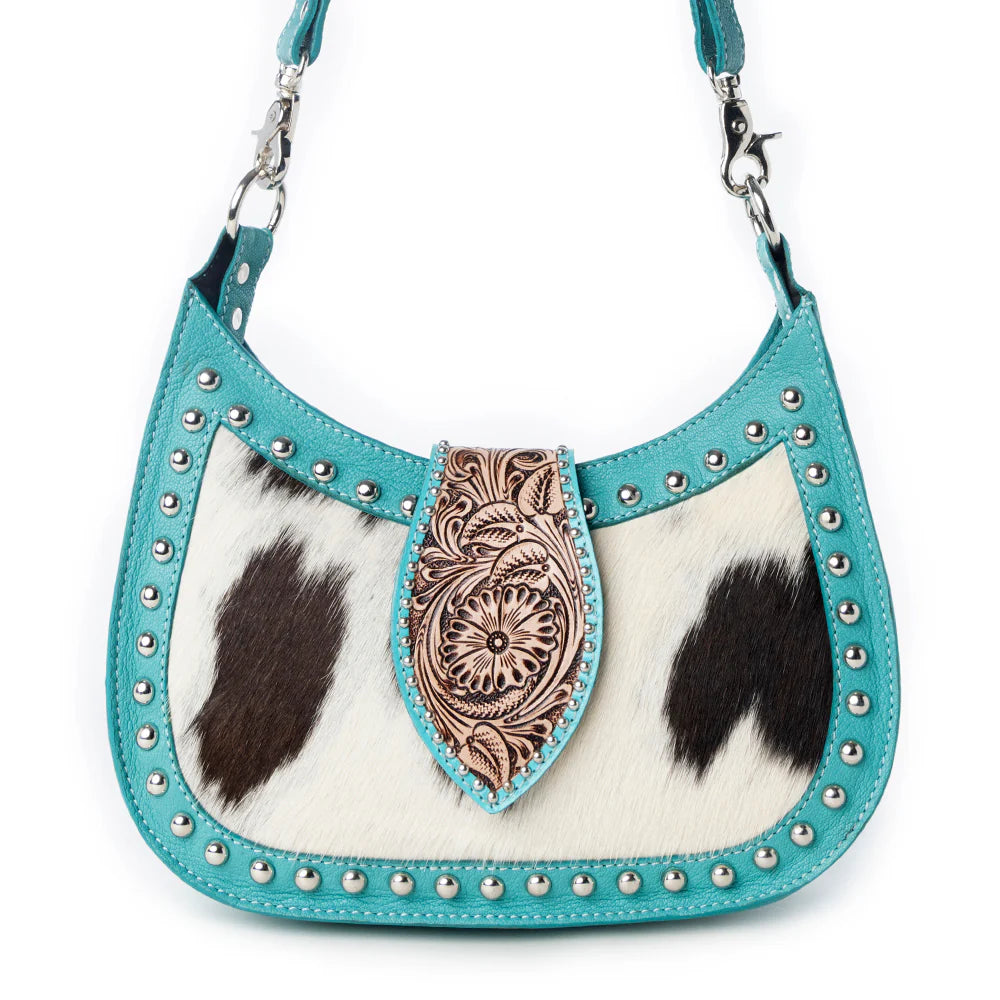 Cowhide handbag with turquoise trim and decorative flap on a white background