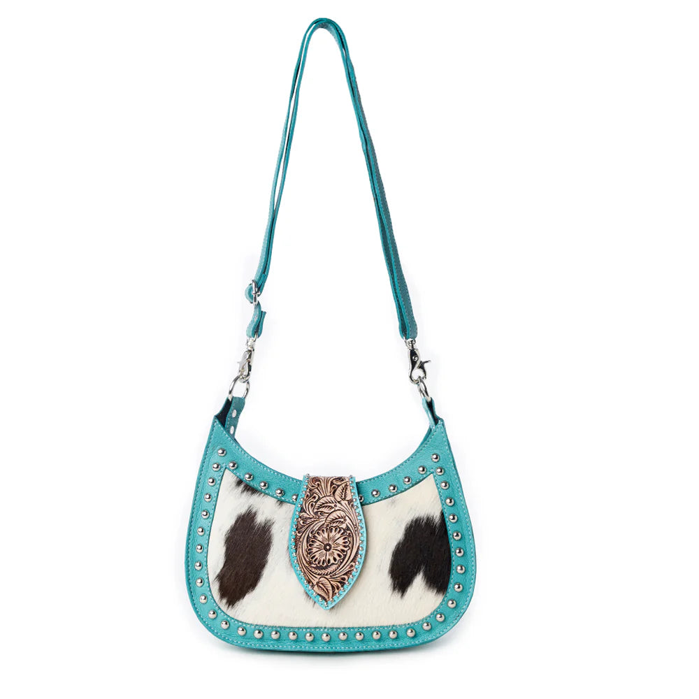 Turquoise handbag with cowhide design and decorative clasp on a white background