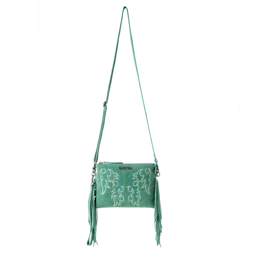 Green crossbody bag with embroidery and fringes on a white background
