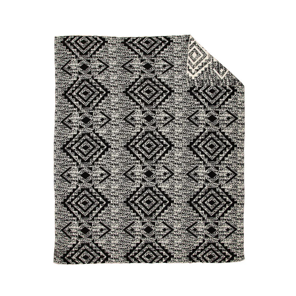 Widespread Aztec Print Throw. Black and white patterned rug on a white background