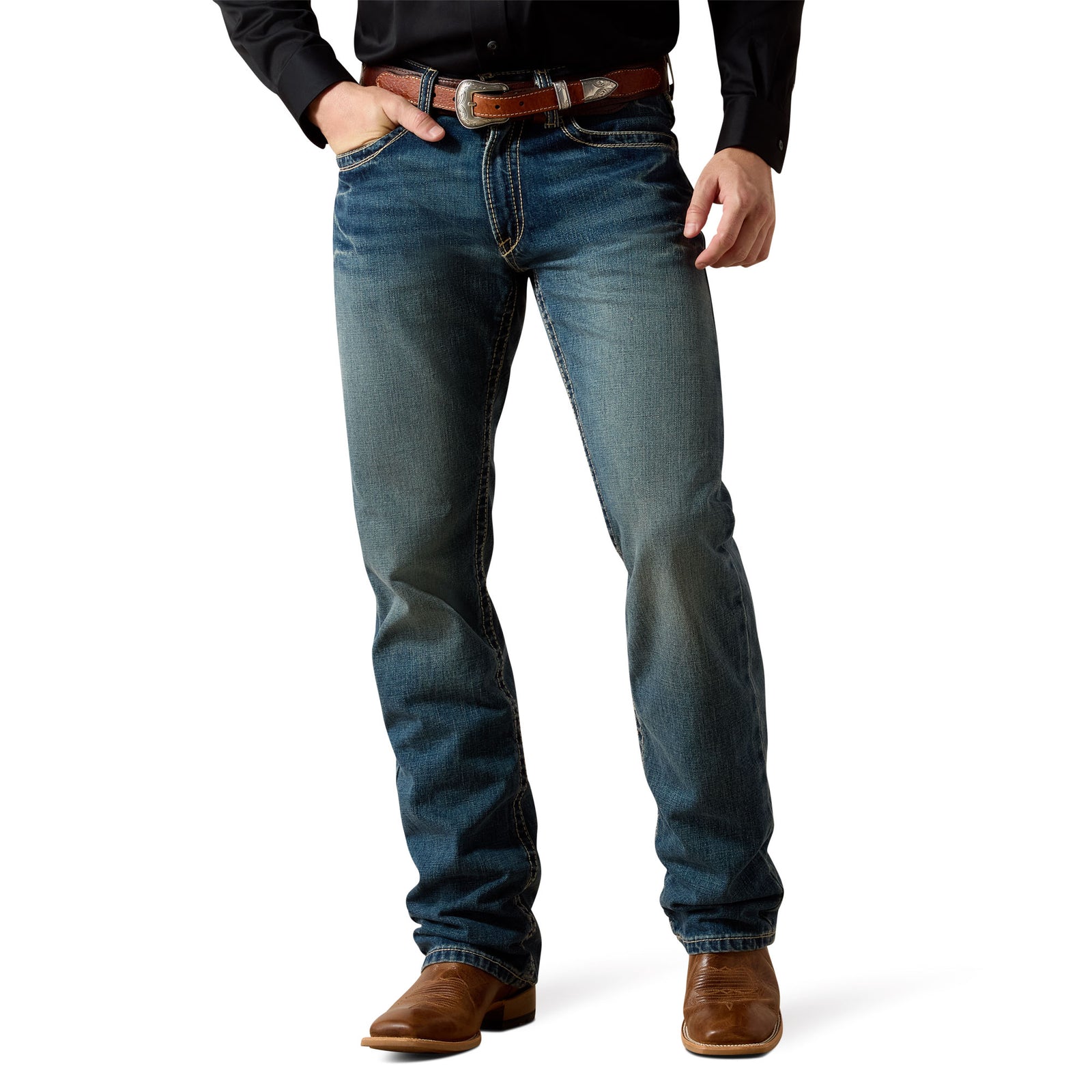 Ariat Men's M5 Boundary Straight Leg Jean. Person wearing blue jeans and brown boots on a white background
