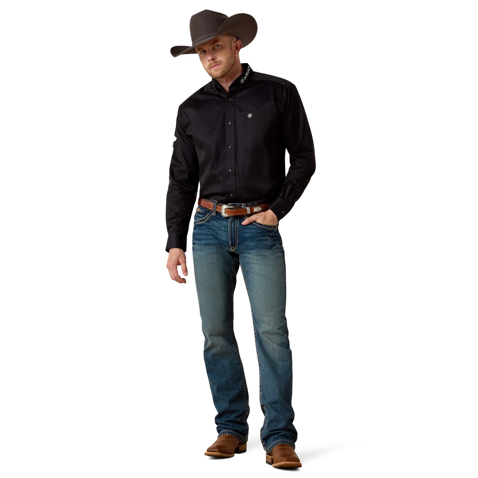 Ariat Men's M5 Boundary Straight Leg Jean. Man wearing a black shirt, blue jeans, and a brown cowboy hat on a white background