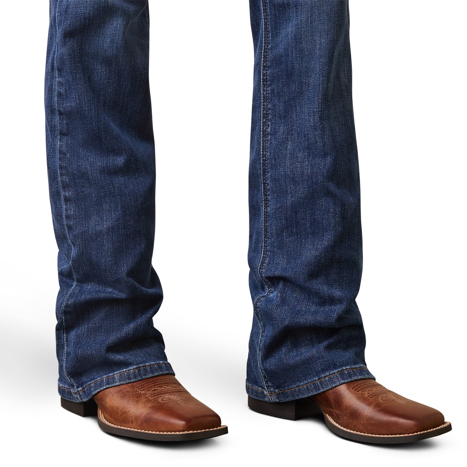 Blue jeans and brown leather boots on a white background