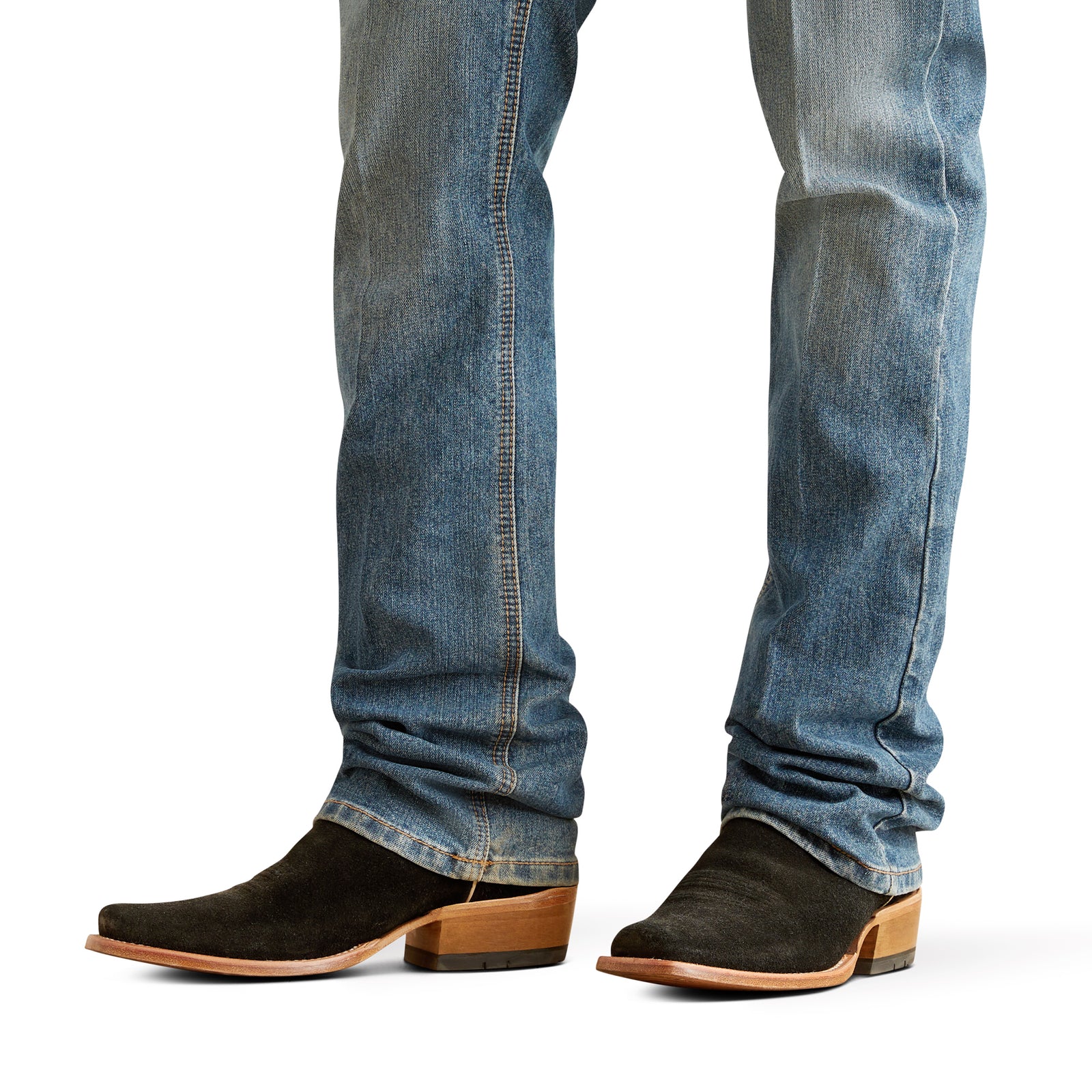 Ariat Men's M5 Performance Pro Rip Straight Leg Jean. Close-up of blue jeans and black suede boots on a white background