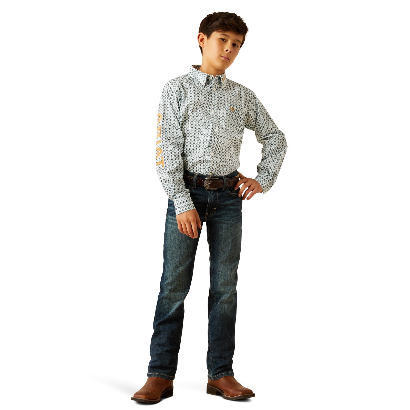 Ariat Boy's Team Franklin L/S Western Shirt. Man wearing a patterned shirt, jeans, and brown shoes on a white background