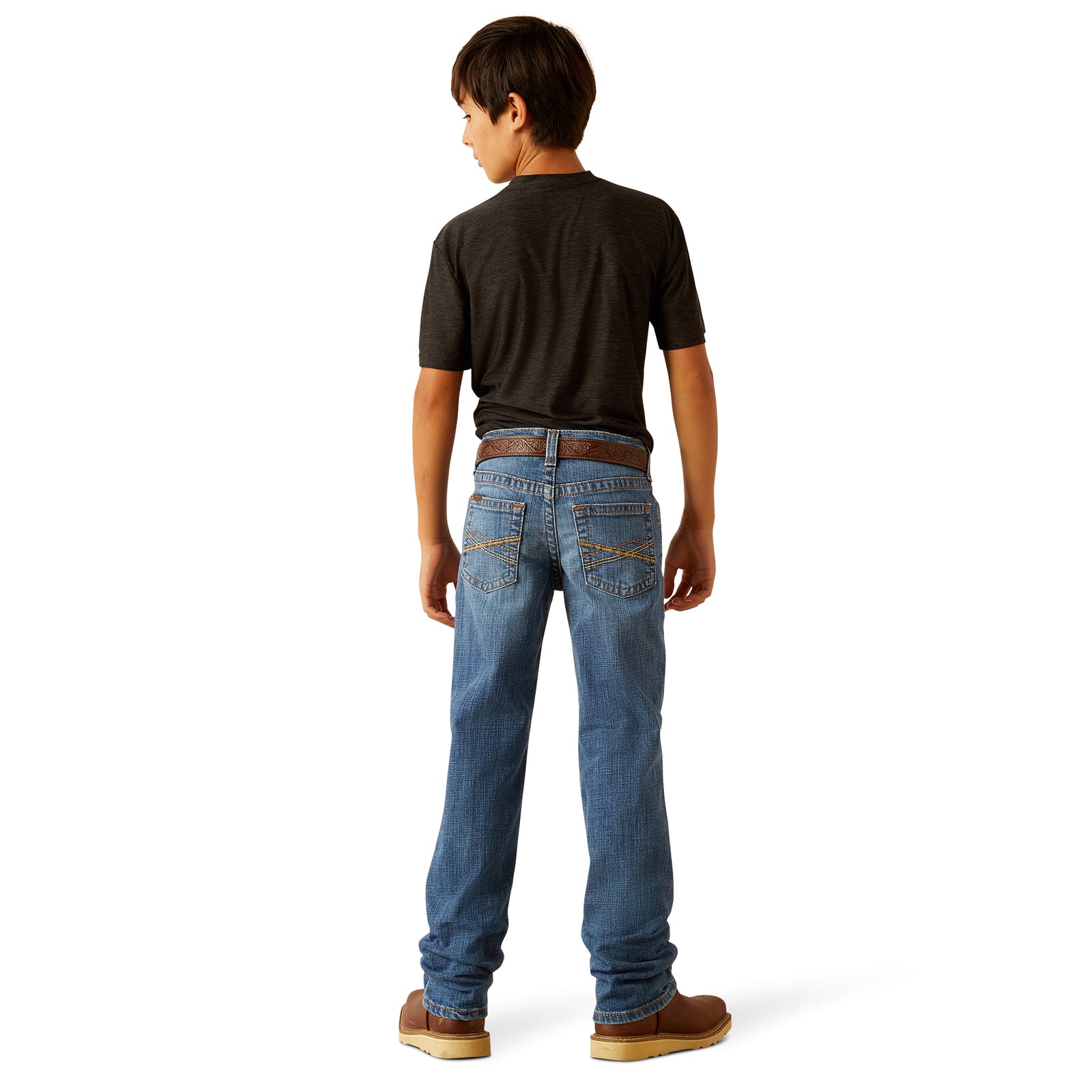 Ariat Boy's B5 Norwich Slim Fit Jean. Person wearing blue jeans and a black shirt on a white background