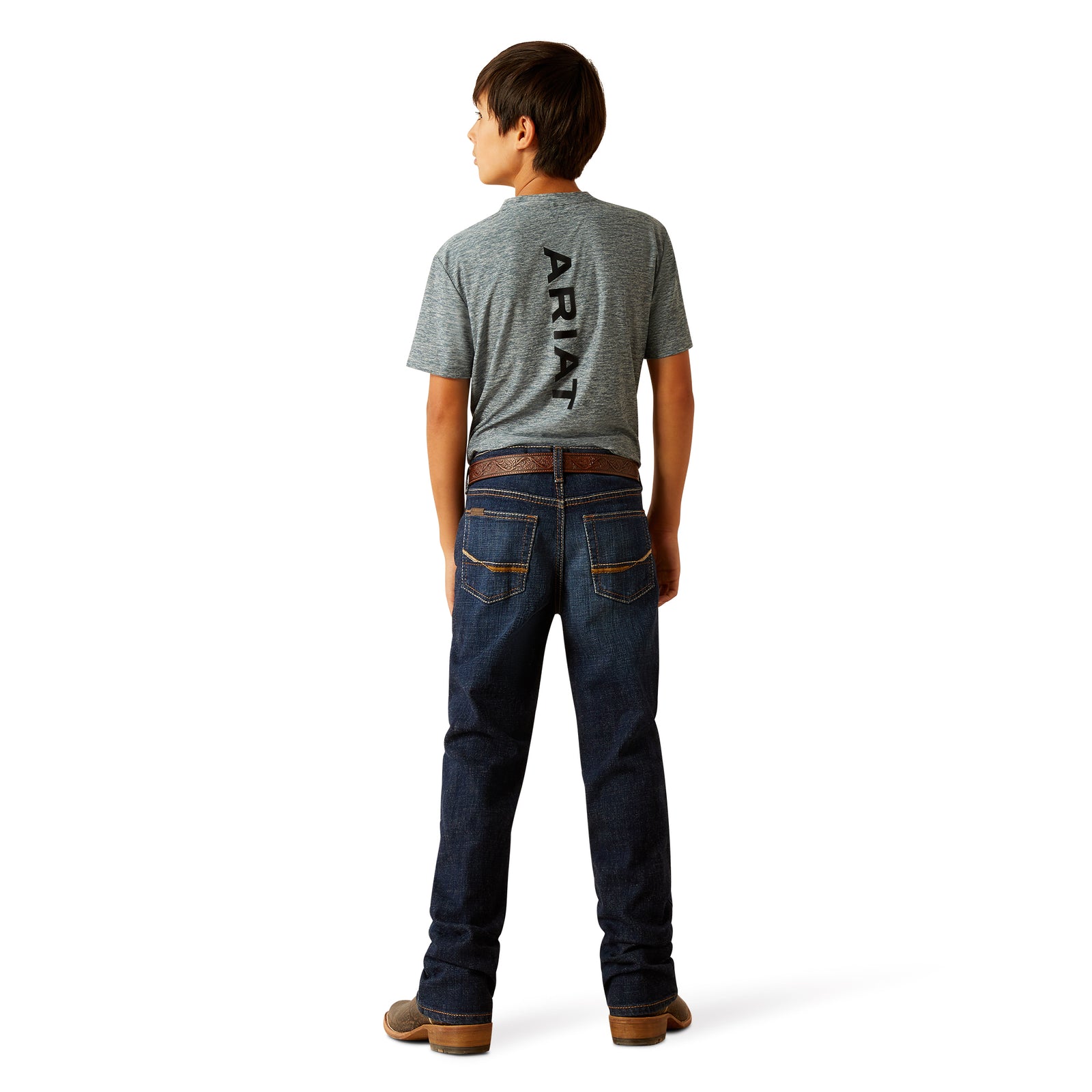 Ariat Boy's B4 Rolland Relaxed Fit Jean. Person wearing a gray t-shirt with 'Ariat' branding and blue jeans on a white background