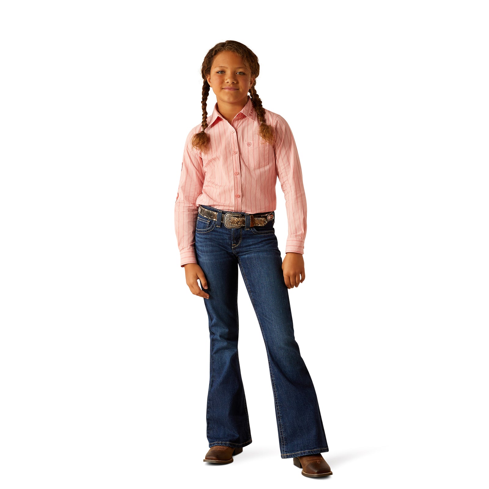 Ariat Girl's Team Kirby L/S Western Shirt. Young girl wearing a pink shirt and blue jeans on a white background