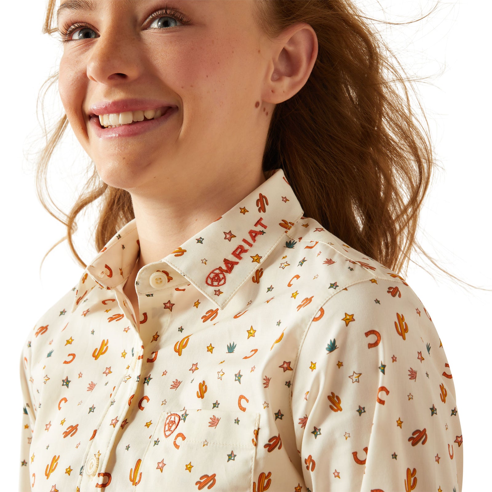 Ariat Girl's Team Kirby L/S Western Shirt. Person wearing a patterned shirt with visible branding on a white background