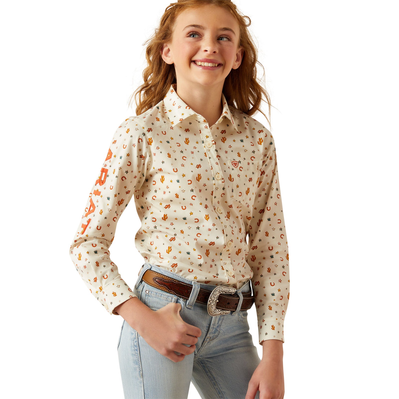 Ariat Girl's Team Kirby L/S Western Shirt. Young girl wearing a floral blouse and jeans on a white background