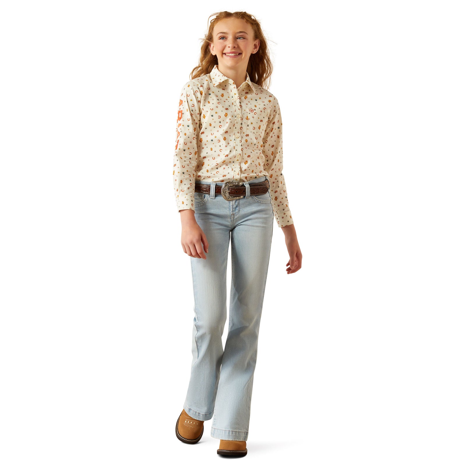 Ariat Girl's Team Kirby L/S Western Shirt. Person wearing a patterned shirt and light blue jeans on a white background