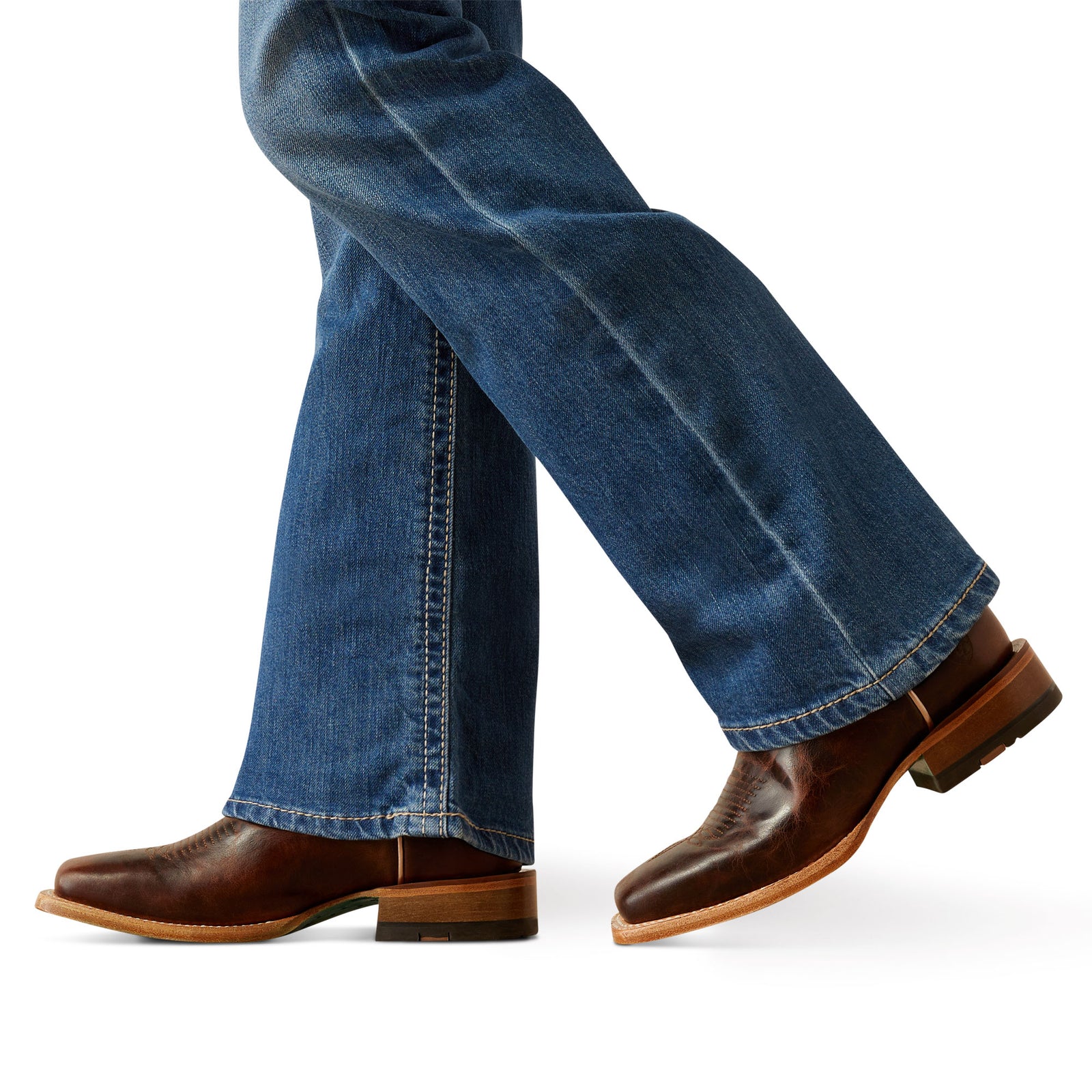 Ariat Girl's Lilla Boot Cut Jeans. Brown leather shoes worn with blue jeans on a white background