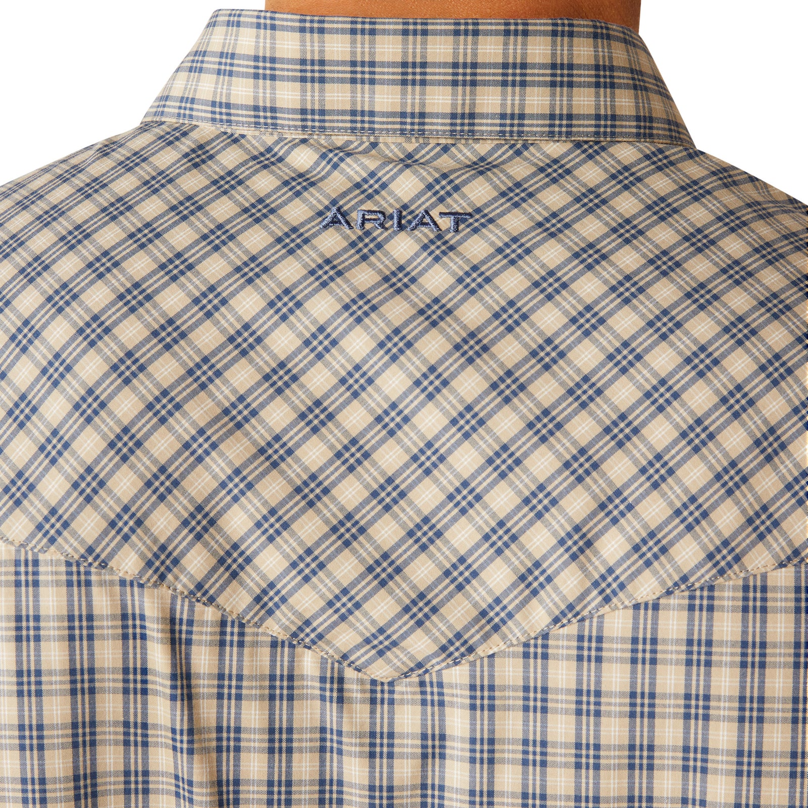 Ariat Men's Pro Series Fairbanks L/S Western Shirt. Close-up of a blue and beige plaid shirt with a brand logo on the collar.