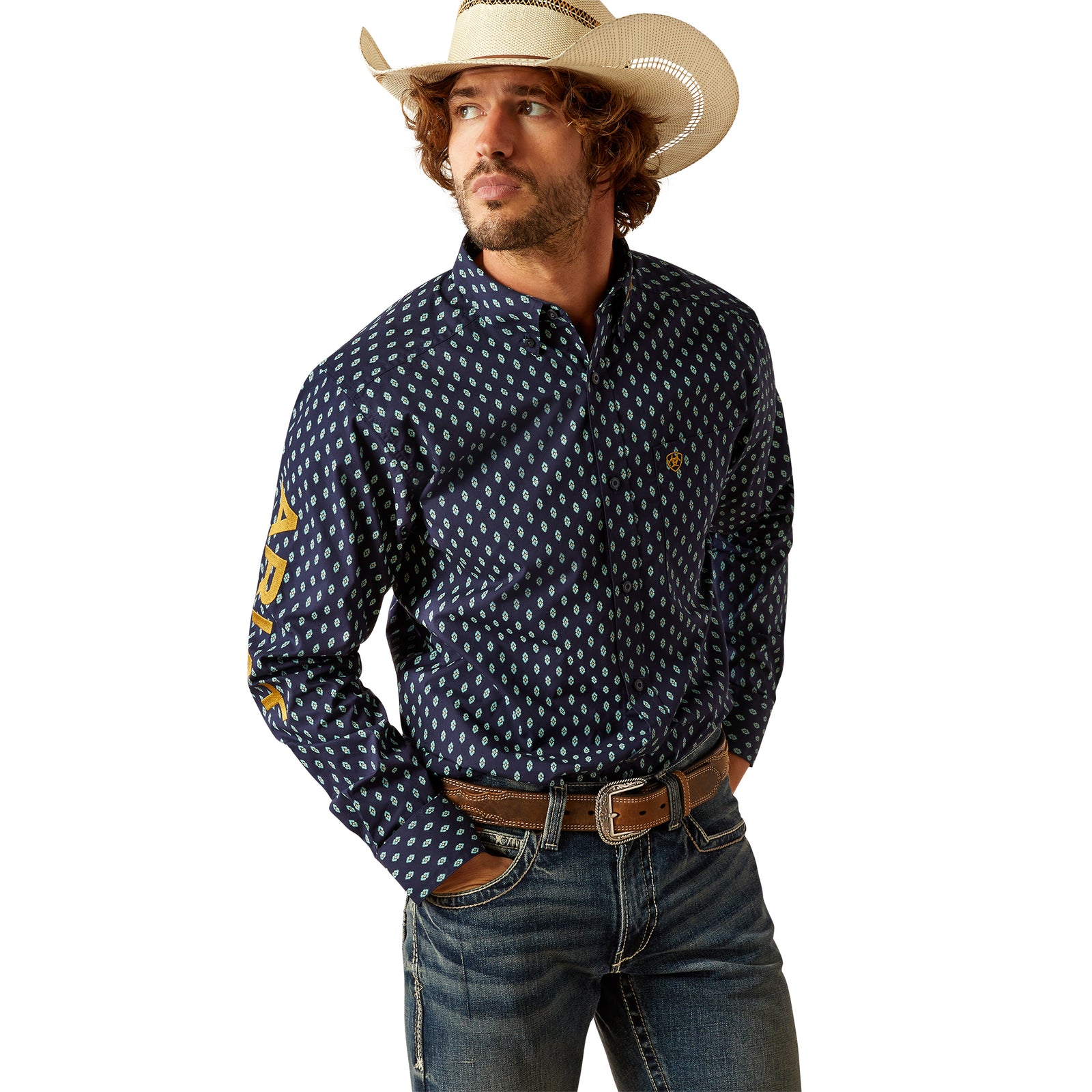 Ariat Men's Team Powell Fitted L/S Western Shirt. Man wearing a cowboy hat, patterned shirt, and jeans on a white background