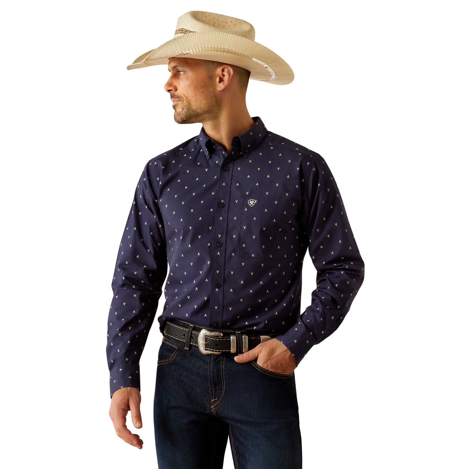 Ariat Men's Cordell Retro Fit L/S Western Shirt. Man wearing a navy patterned shirt, jeans, and a straw cowboy hat on a white background