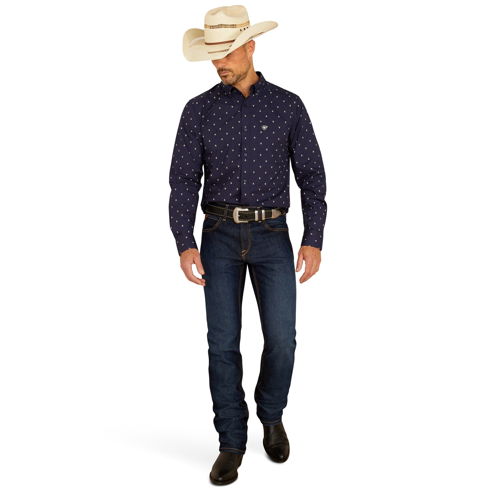 Ariat Men's Cordell Retro Fit L/S Western Shirt. Man wearing a dark blue patterned shirt, jeans, and a cowboy hat on a white background