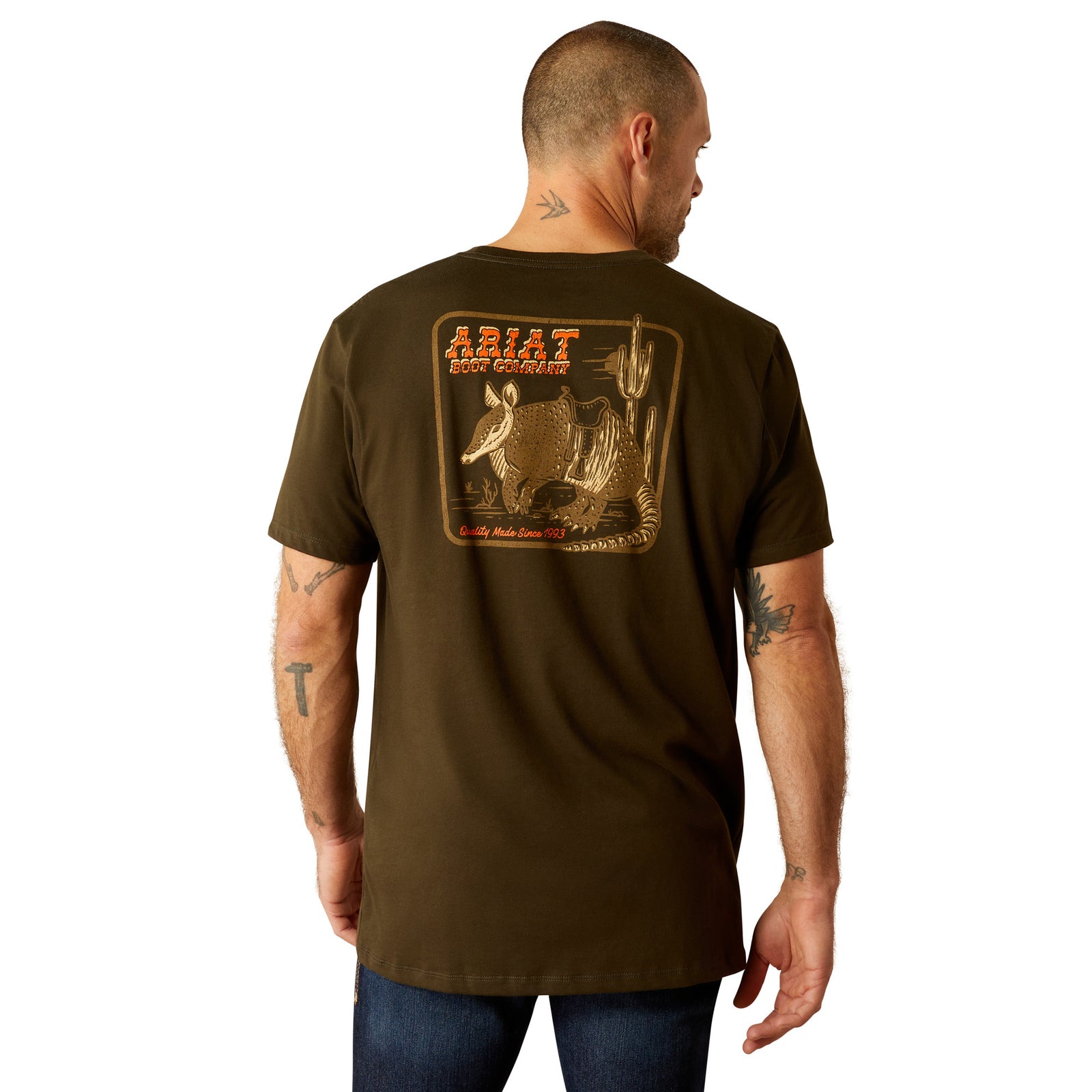 Ariat Men's Armadillo on a Half Shell T-Shirt. Men's brown short-sleeved T-shirt with a graphic print of an armadillo on the back.