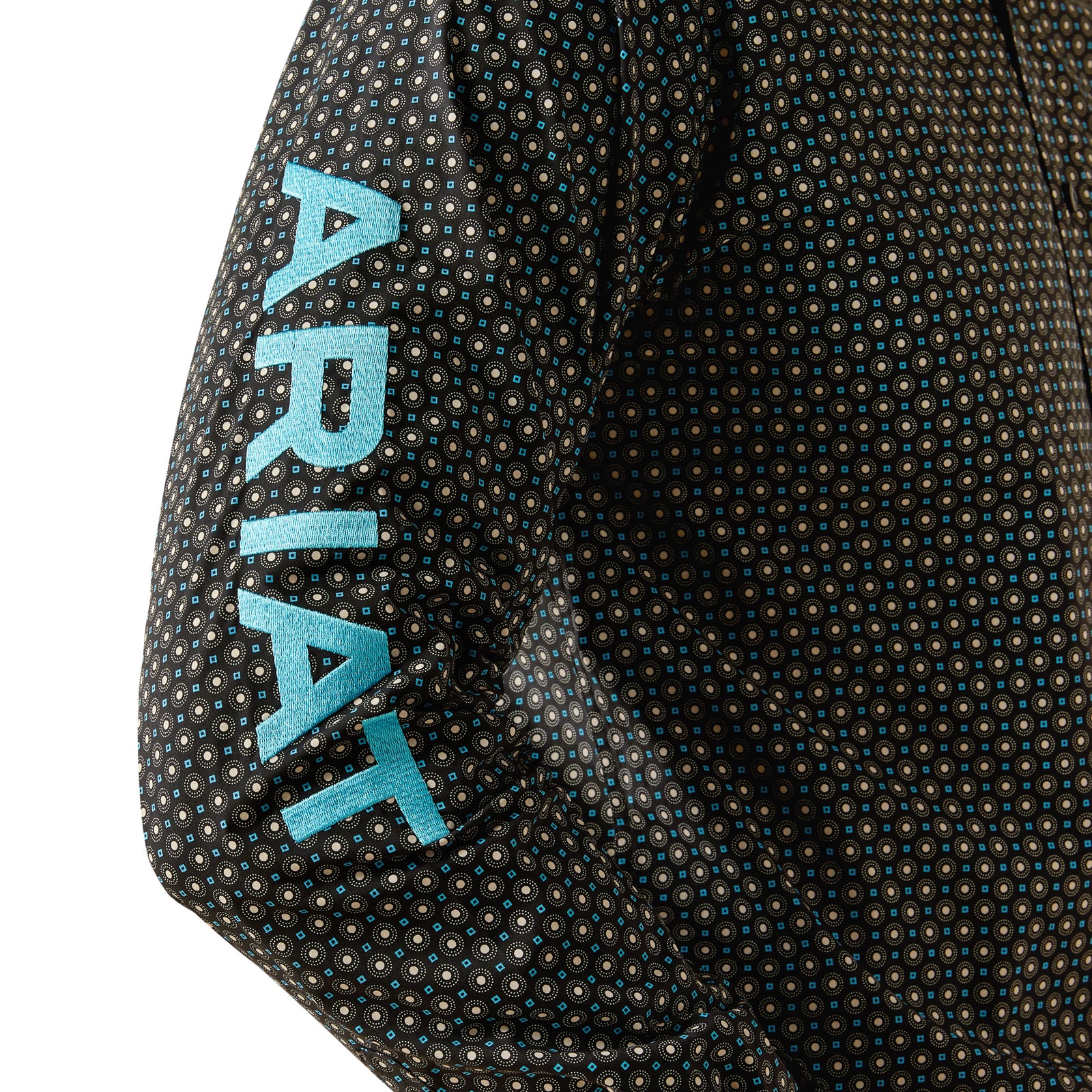 Ariat Men's Team Abel Fitted L/S Western Shirt. Close-up of a textured jacket sleeve with 'Ariat' branding.