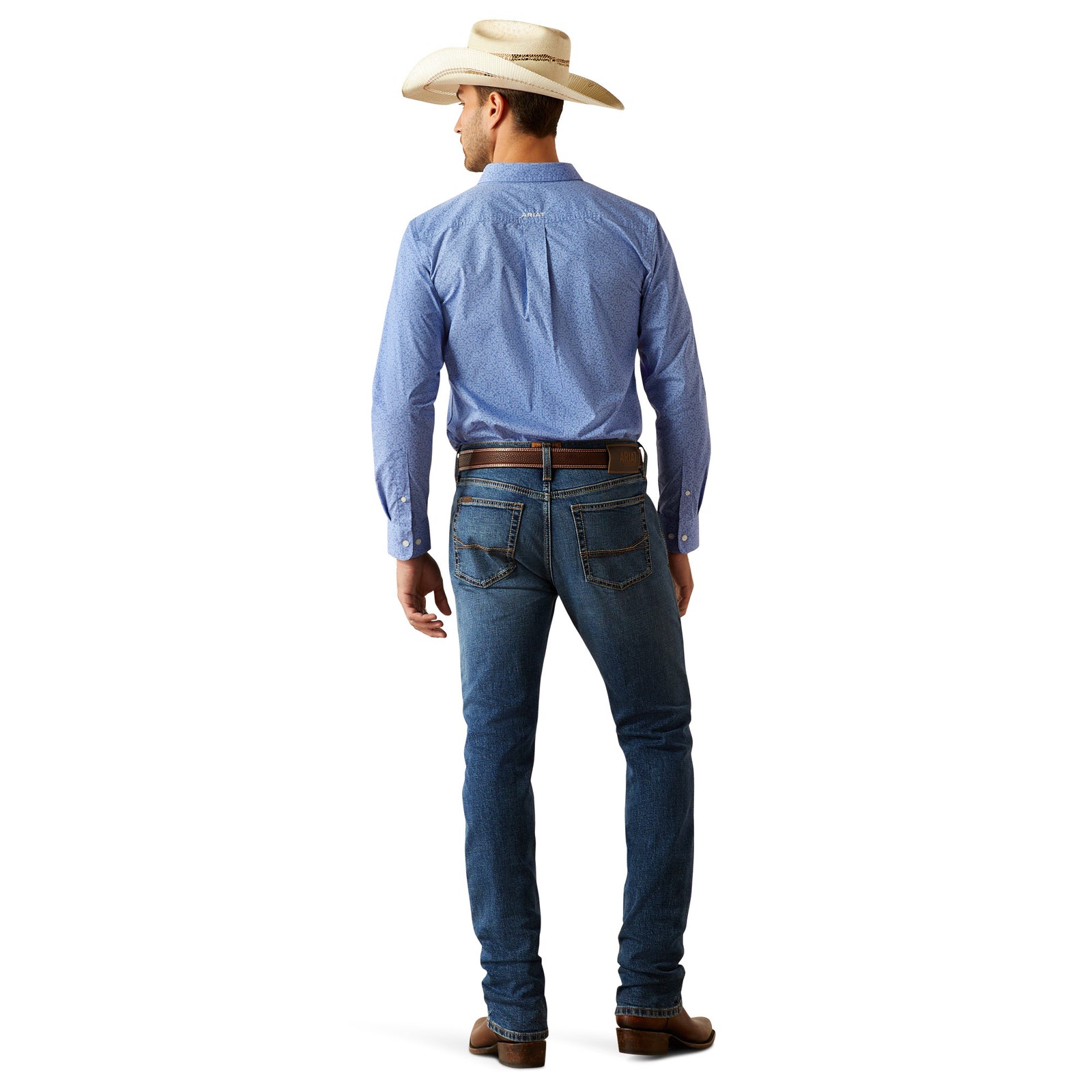 Ariat Men's M8 Miles Modern Fit Jean. Man wearing a blue shirt, jeans, and a cowboy hat on a white background