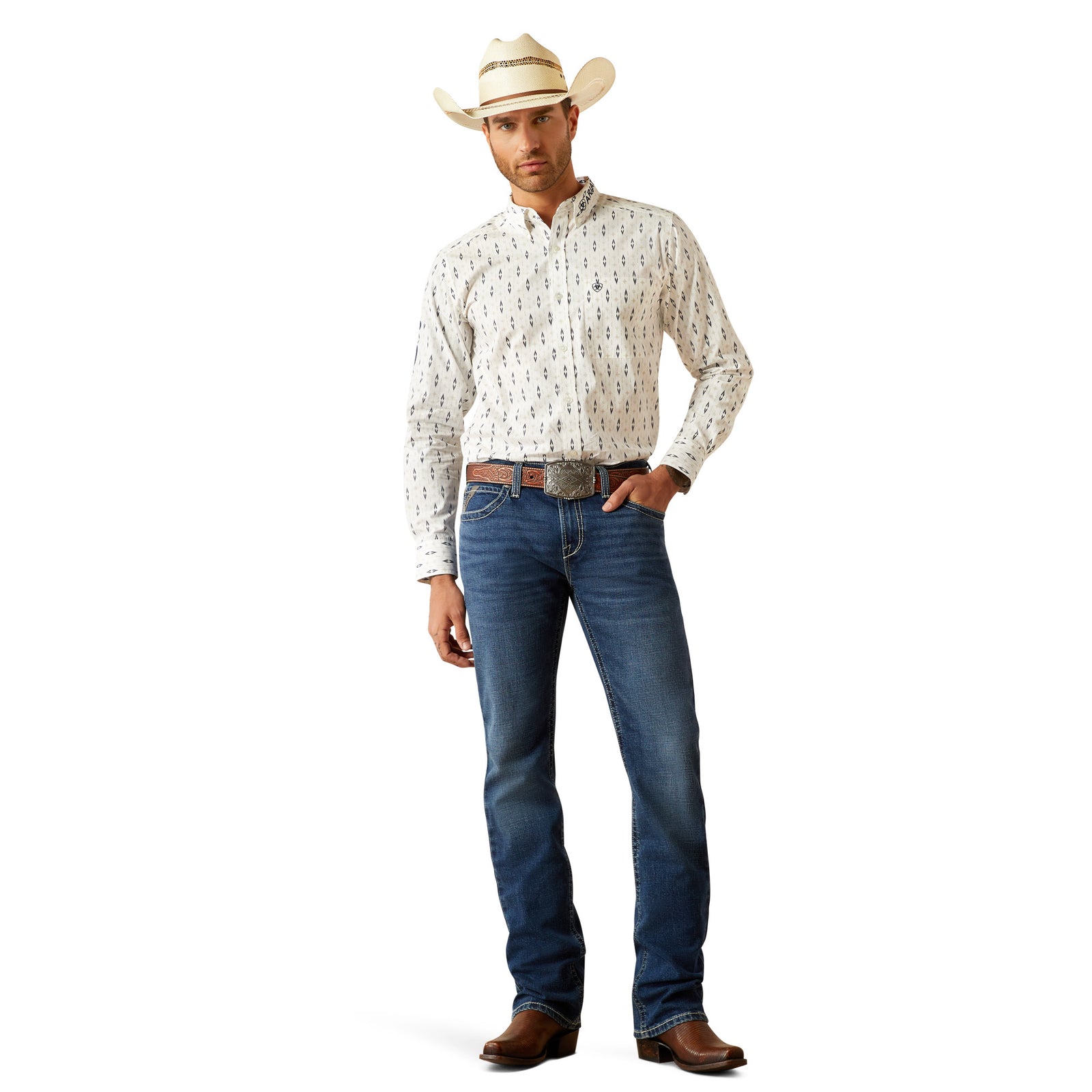 Ariat Men's M7 Wesley Slim Straight Leg Jean. Man wearing a white patterned shirt, blue jeans, and a cowboy hat on a white background