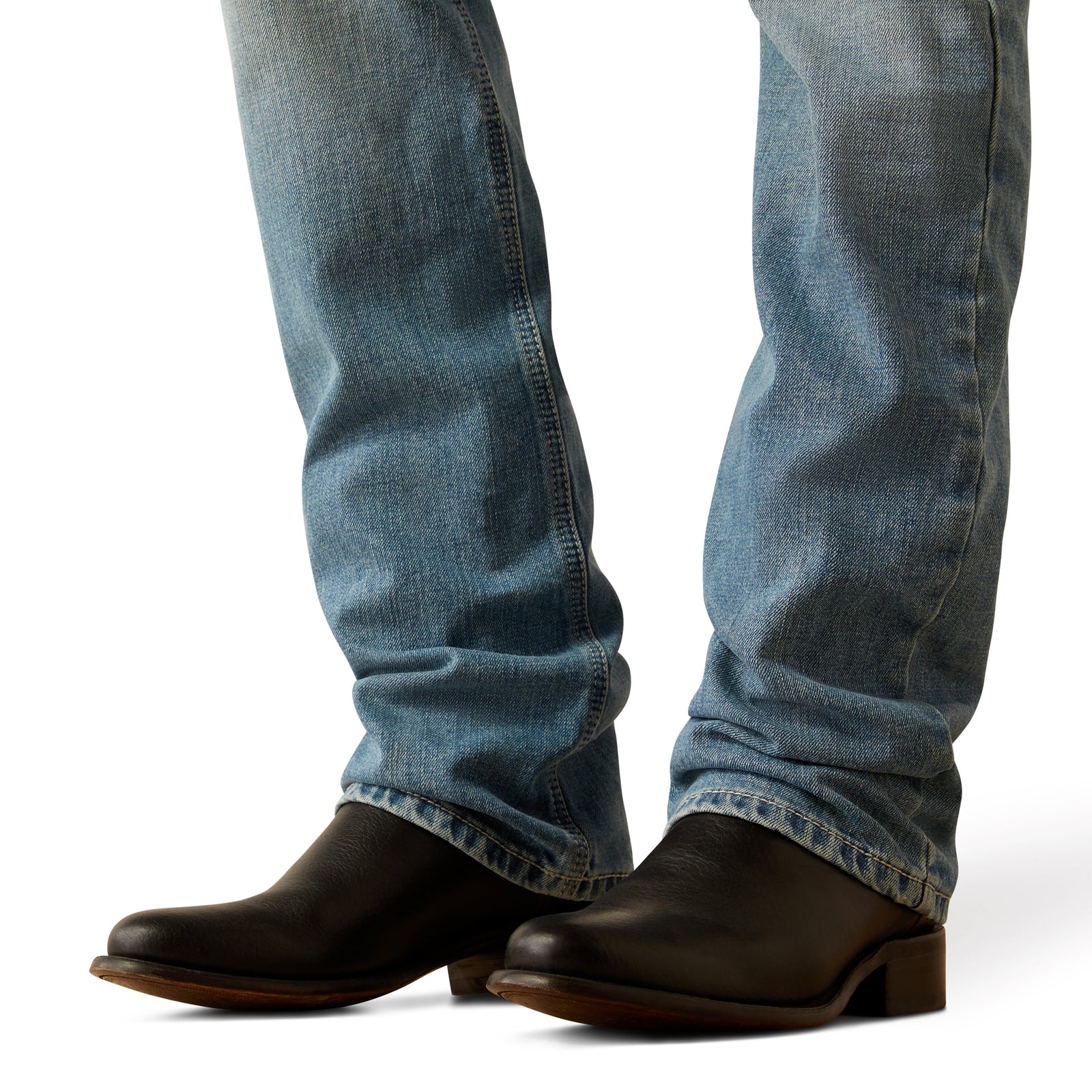 Ariat Men's M7 Ethan Slim Straight Leg Jean. Blue jeans and black boots on a white background