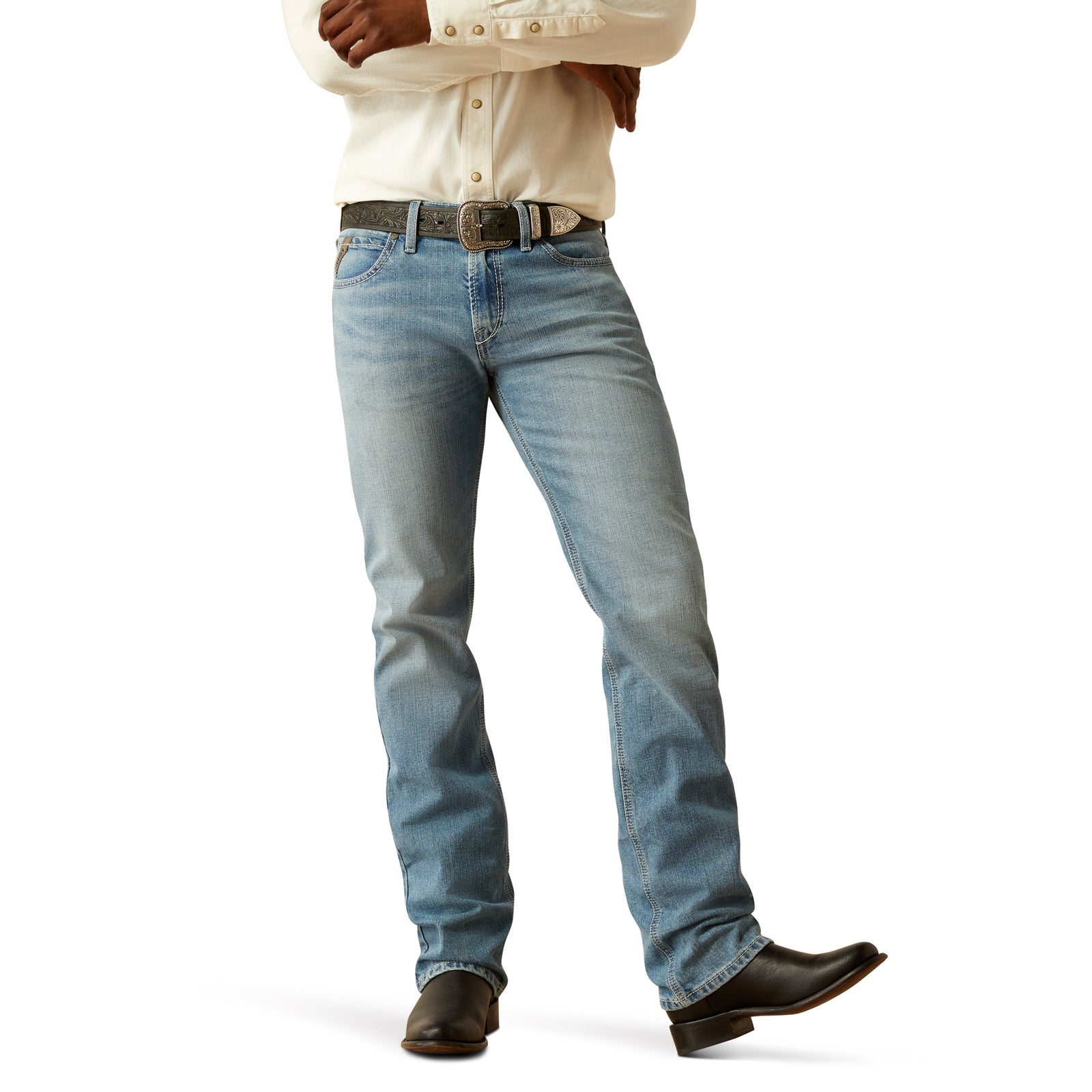 Ariat Men's M7 Ethan Slim Straight Leg Jean. A man wearing slim straight leg blue jeans and a white shirt with rolled-up sleeves.