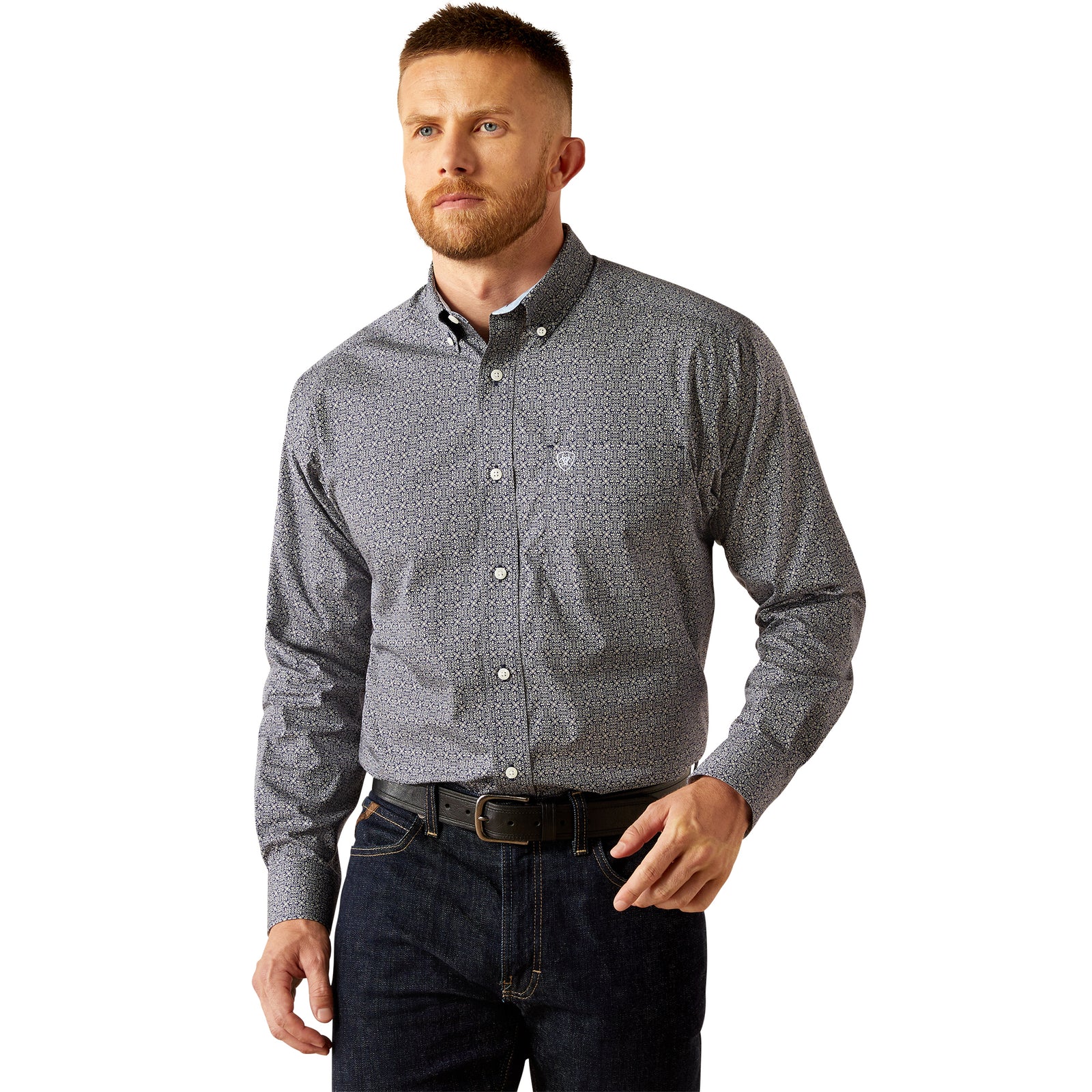 Ariat Men's Wrinkle Free Douglas L/S Western Shirt. Man wearing a patterned gray shirt and dark jeans on a white background