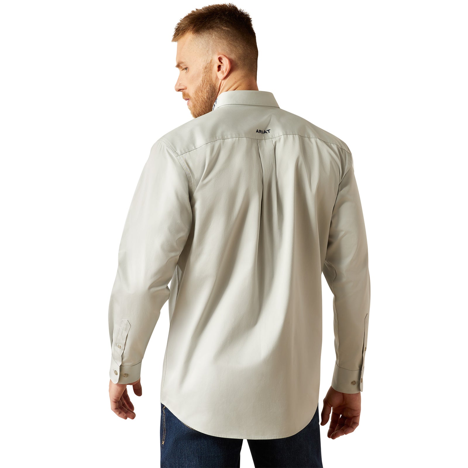 Ariat Men's Team Logo Twill L/S Western Shirt. Man wearing a beige long-sleeve shirt on a white background