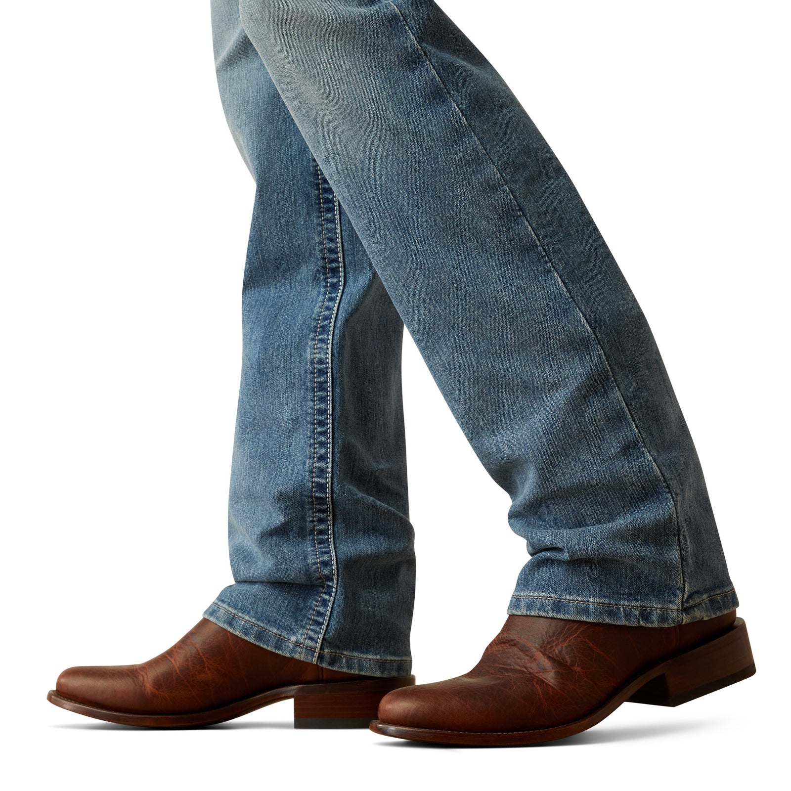 Ariat Men's M5 Forrest Straight Leg Jeans. Blue jeans and brown shoes on a white background