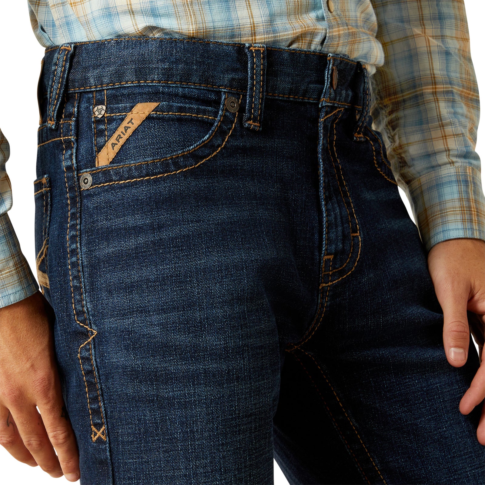 Ariat Men's M8 Modern Shawn Straight Leg Jean. Close-up of blue jeans with a brand logo on a white background