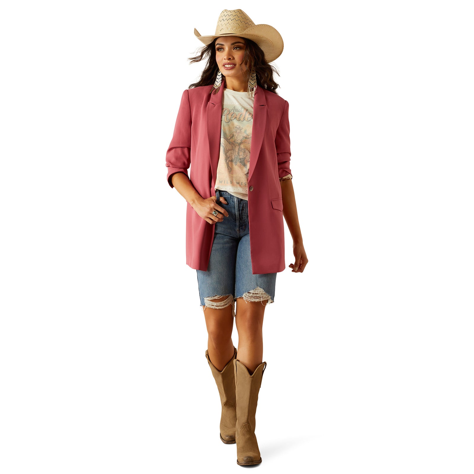Ariat Women's Ella Blazer. Woman wearing a pink blazer, denim shorts, and cowboy boots on a white background
